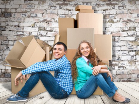 Packed moving boxes and furniture for a home move in Maida Hill