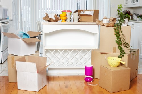 Local moving team organising boxes in a West London flat