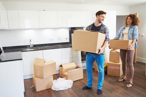 Professional movers loading household items for transport in Maida Hill