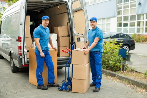 Movers carrying boxes in a Maida Hill flat conversion